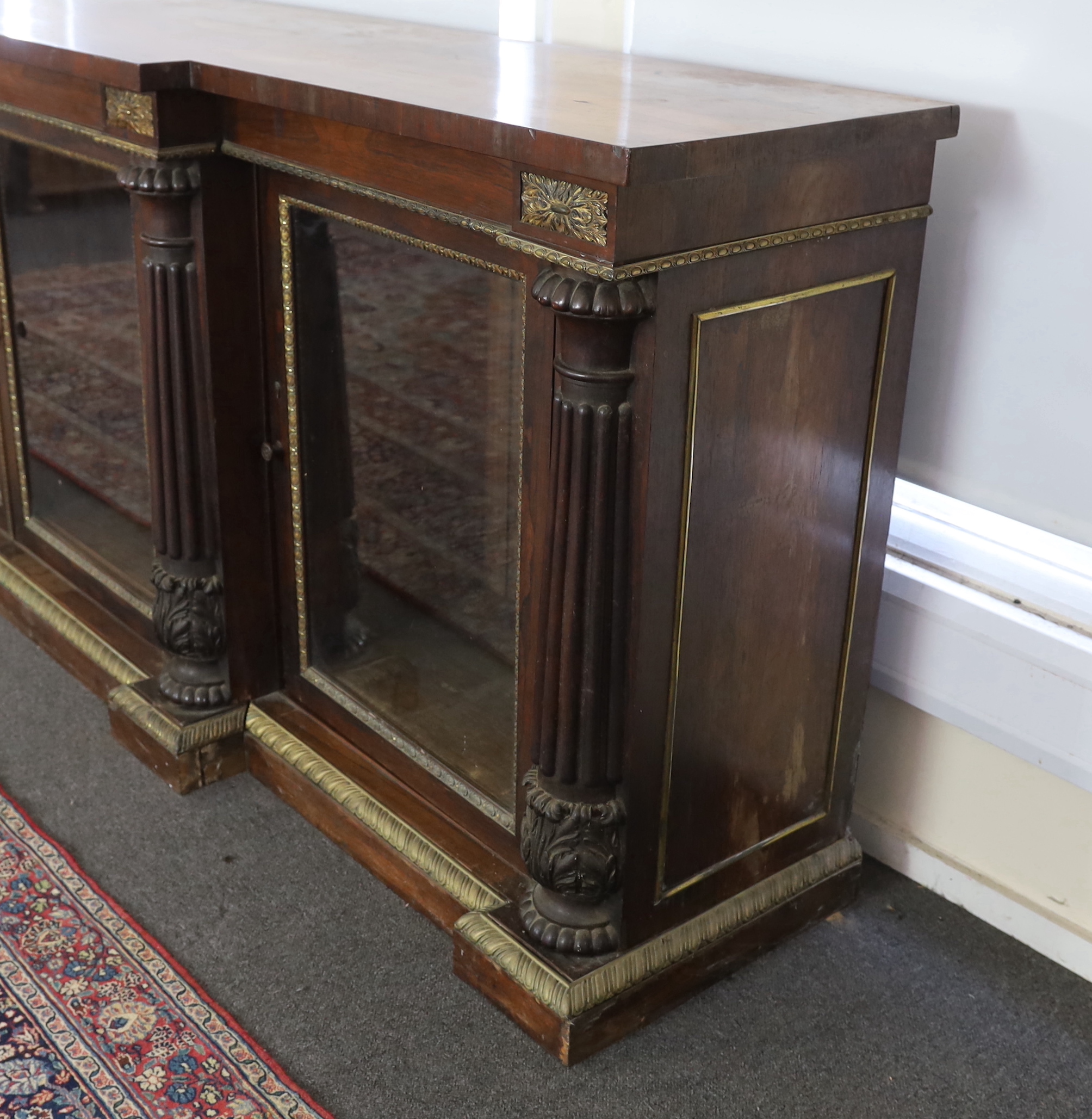 A George IV ormolu mounted rosewood breakfront dwarf bookcase, width 306cm, depth 60cm, height 102cm